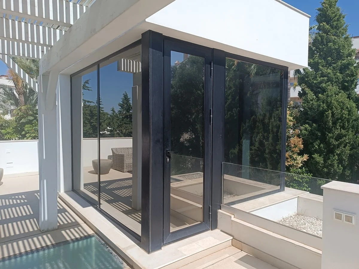 Window film on the corner bifold doors of a modern villa in Nueva Andalucía