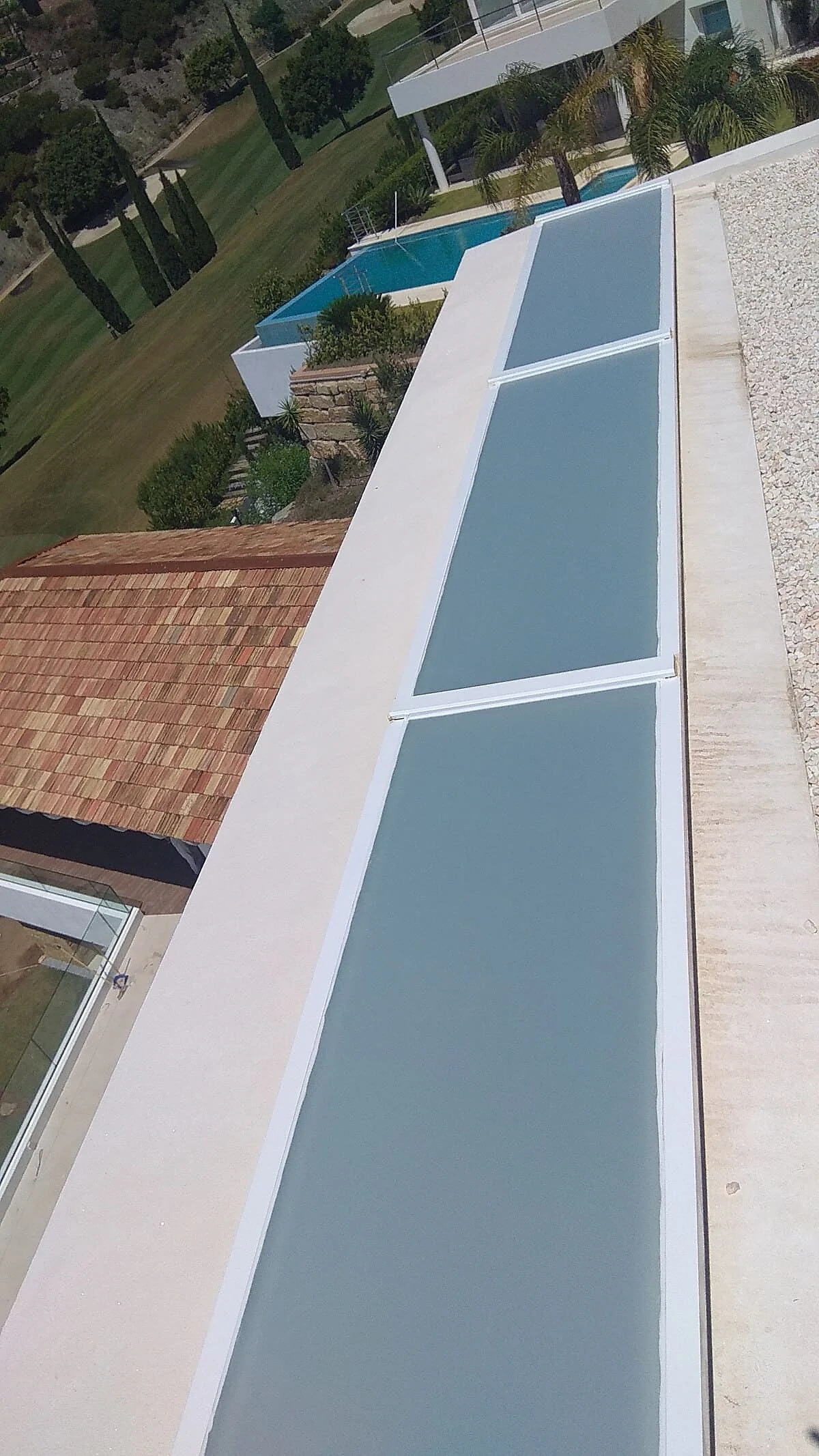 Privacy film on a glazed roof panel between properties in Manilva