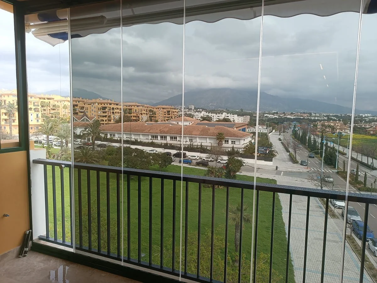 Window tinting on a glazed villa terrace in Marbella with mountain views